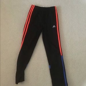 Grey adidas pants with blue and orange stripes